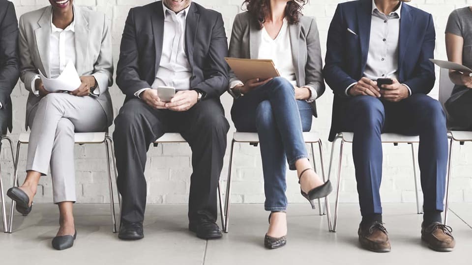 employees sitting on chairs talking